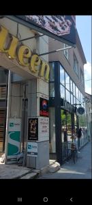 a store with a sign on the front of it at Apartmani Queen in Kraljevo