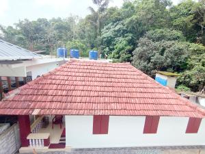 a roof of a house with a red roof at Olivia Homestay Idukki in Idukki