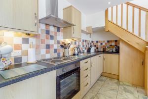 a kitchen with a sink and a stove top oven at Jim's Barn in Diggle