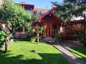 a house with a lawn in front of it at Patak28 Apartmanok in Sopron