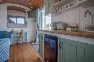 a kitchen with a sink and a counter top at Rosemary - 1 Bedroom Shepherds Hut - Amroth in Amroth