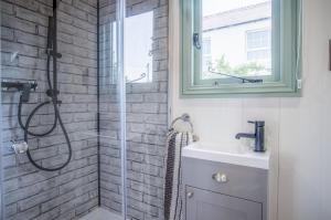 a bathroom with a shower and a sink at Rosemary - 1 Bedroom Shepherds Hut - Amroth in Amroth +22 photos
