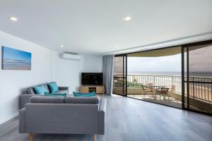 a living room with a couch and a view of the ocean at The Breakers in Gold Coast