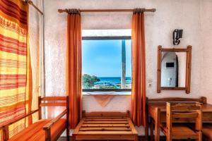 a room with a window with a view of the ocean at Hotel Tsagarakis Beach in Amoudara Herakliou
