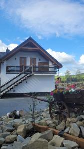 a house with a wheelbarrow in front of it at Apartamenty Home&Spa in Rabka-Zdrój