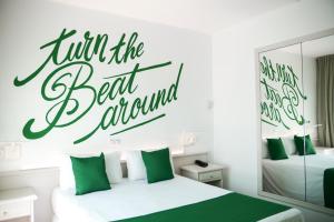 a bedroom with two beds and a sign that reads fill the best aquarium at Lloret Vibe Affiliated by FERGUS in Lloret de Mar