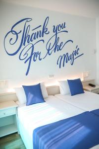 a bedroom with two beds with words thank you for the music at Lloret Vibe Affiliated by FERGUS in Lloret de Mar