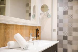 a bathroom with a white sink and a mirror at Lloret Vibe Affiliated by FERGUS in Lloret de Mar