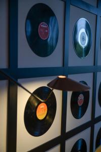 a room with two records on a wall at Lloret Vibe Affiliated by FERGUS in Lloret de Mar