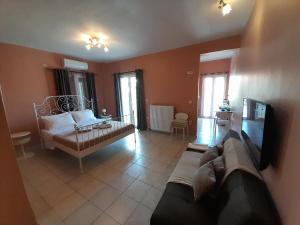 a living room with a couch and a tv at Nestor Sea Studio in Preveza