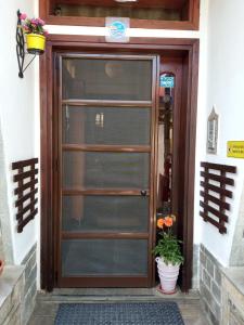 a door to a building with a potted plant at Marika House in Stavros