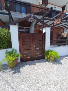a wooden gate in front of a building at Marika House in Stavros