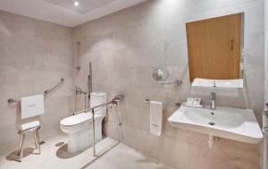 a bathroom with a sink, toilet and bathtub at Sercotel Alcalá 611 in Madrid