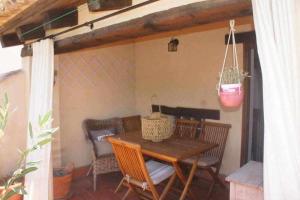a wooden table and chairs on a patio at Rubielos de Mora Ollerías in Rubielos de Mora