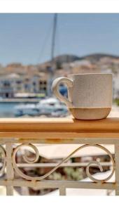 a coffee cup sitting on top of a table at Nomade vibrant living loft in Ermoupoli