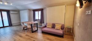 a room with a table and a couch and a table and chairs at Casa Barcelli Sport & Family Apartments in Nago-Torbole