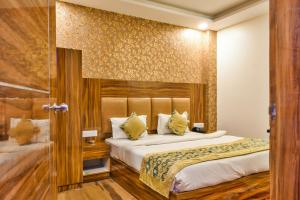 a hotel room with two beds and a glass door at Olivia Stay in New Delhi