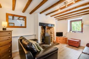 a living room with a couch and a fireplace at 3 Tyn Y Mynydd in Betws-y-coed