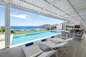 a villa with a swimming pool and a view of the ocean at Villa Vrachos in vlicha