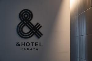 a sign on the side of a building at &HOTEL HAKATA in Fukuoka +33 photos