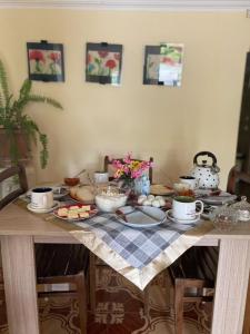 a table with a table cloth with food on it at Hostel DIA in Tsqaltubo