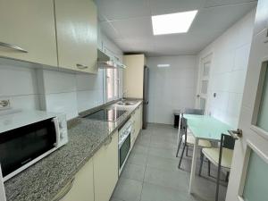 A kitchen or kitchenette at Apartamentos Valparaiso II
