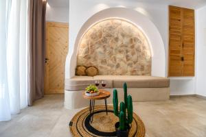 a room with a bed and a table with a cactus at Aggeliki's Diamond in Agia Anna Naxos