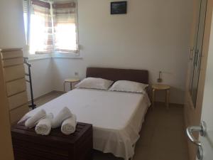 a bedroom with a bed with two towels on it at Apartment Vjera in Punat