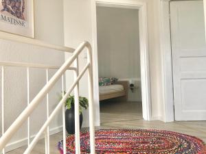 a white staircase with a potted plant in a room at Wohlfühl Villa Garding in Garding