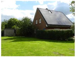 a house with a bunch of solar panels on it at Wohlfühl Villa Garding in Garding