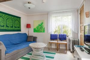 a living room with a blue couch and blue chairs at Holiday apartment in Vimmerby with cozy courtyard in Vimmerby