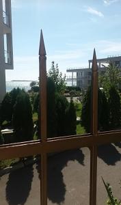 a fence with a view of a building at Le Premiére Randevu in Sveti Vlas