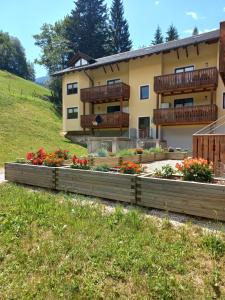 a house with flower beds in front of it at Wald Residence in Bad Kleinkirchheim