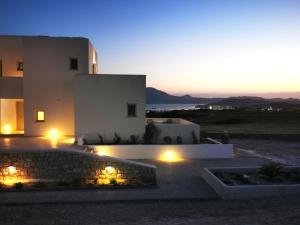 a building with lights in front of it at night at Κallisto rooms in Mytakas