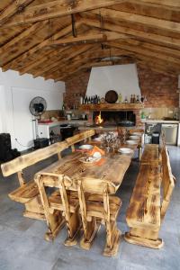a large wooden table with benches in a kitchen at Apartments Bella in Vodice