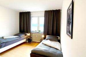 a bedroom with two beds and a window at 3 room apartment in Lengerich in Lengerich