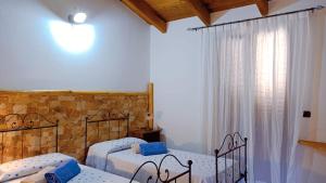 A bed or beds in a room at Agriturismo Gragonti, Arbus Costa Verde