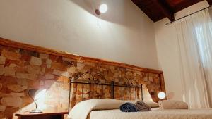 A bed or beds in a room at Agriturismo Gragonti, Arbus Costa Verde