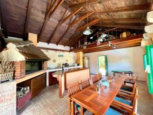 a dining room with a table and a kitchen at Villa Sagosde with Swimming Pool and Mini Golf in Zagvozd