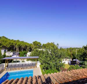 a view of a pool from the roof of a house at Villa Geckos Charming holiday finca 5 min by car to the fabulous Cala Salada beach in San Antonio