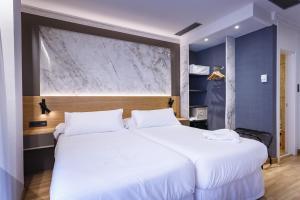 Postel nebo postele na pokoji v ubytování Hotel Dauro Premier