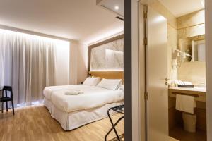 Postel nebo postele na pokoji v ubytování Hotel Dauro Premier