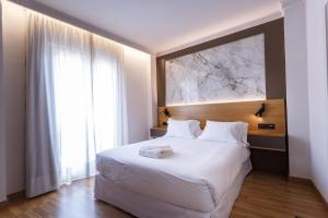 Postel nebo postele na pokoji v ubytování Hotel Dauro Premier