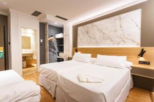 Postel nebo postele na pokoji v ubytování Hotel Dauro Premier