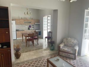 a kitchen and living room with a table and chairs at Traditional SeamansHouse Kochilos in Rogón