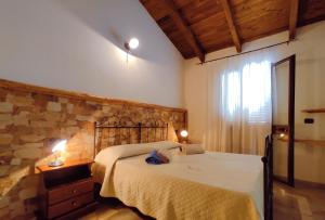 A bed or beds in a room at Agriturismo Gragonti, Arbus Costa Verde