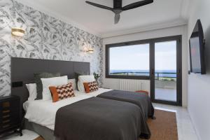 a bedroom with a bed and a large window at SA GUARDA in Llafranc +63 photos