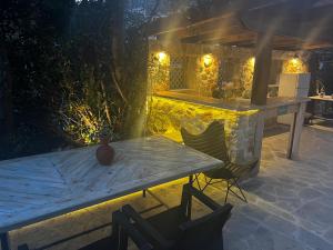 a table and chairs on a patio at night at Blue Maris in Sutomore