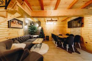 a living room with a couch and a christmas tree at Vila Rudnicka Idila in Gornji Milanovac