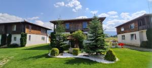 a large house with a yard with grass and trees at Villa Nikol Apartment #1 in Raduil +28 photos
